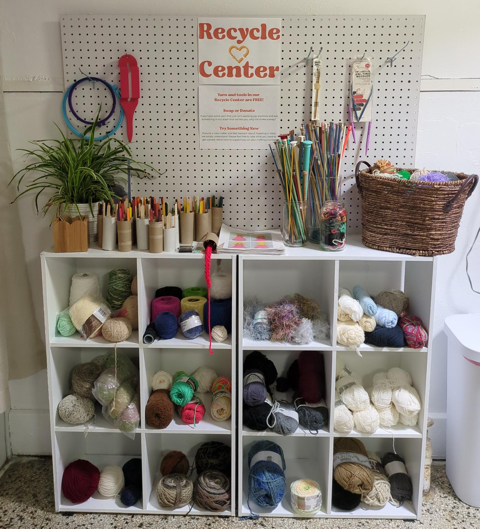 Recycle center with yarn and crafting tools.